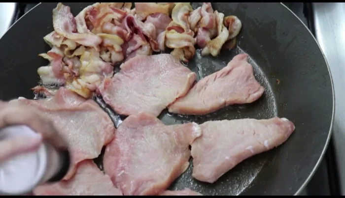 Season pork chops with garlic powder, onion powder, salt, and pepper.