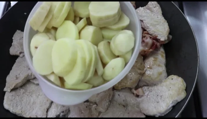 Add potatoes to the pan with the pork chops.