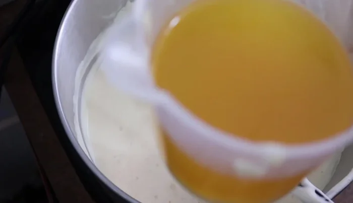 Add melted butter (225g or 1 cup) in a thin stream while beating.