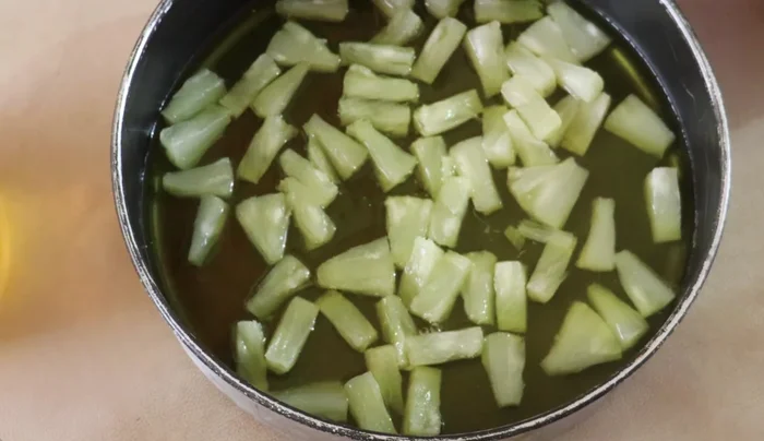 Pour a portion of the prepared pineapple gelatin over the pineapple slices to cover them. Refrigerate until semi-set (about 3 minutes).