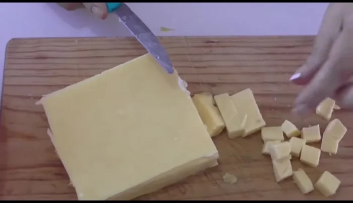 Prepare the potato filling: Chop Manchego cheese into small pieces.