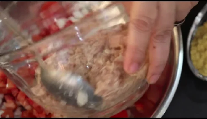 Combine tuna filling: In a bowl, mix the chopped tomatoes and onion with the tuna. Break up the tuna to prevent large chunks (187.72). Add granulated bouillon and Italian herbs (227.84).