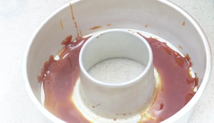 Pour the blended mixture into the mold over the caramel.