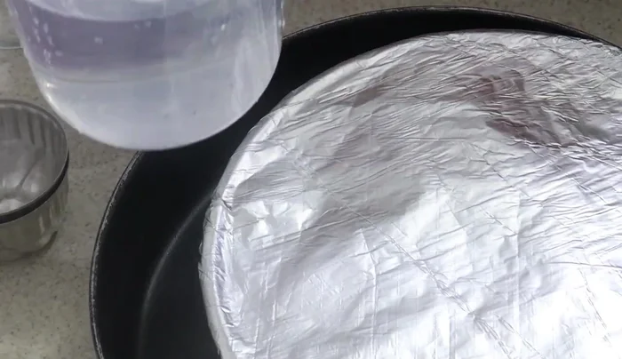 Preheat oven to 200°C (392°F). Place the mold in a larger pan, add hot water halfway up the sides of the mold. Bake for about an hour, or use a stovetop method with a lidded saucepan for about an hour.