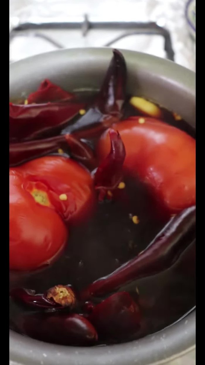 Boil 20 guajillo chiles, 2 round tomatoes, 3 garlic cloves, and half an onion.