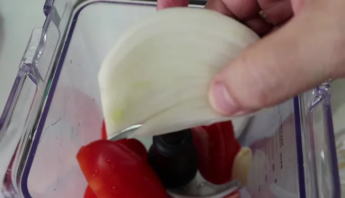 In a blender, combine tomatoes, garlic, onion, broth, and 1 cup of water (the same cup used to measure the rice). Blend until smooth.