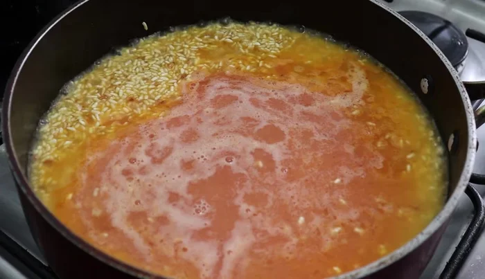 Add the strained mixture to the fried rice. Stir and cook for 3-5 minutes over medium heat.