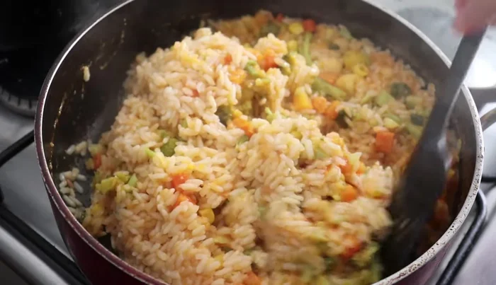 After 15-20 minutes, gently stir the rice to ensure even cooking.