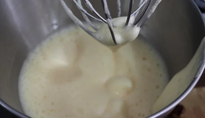 In a separate bowl, melt butter. Add 0.5 cup of milk.