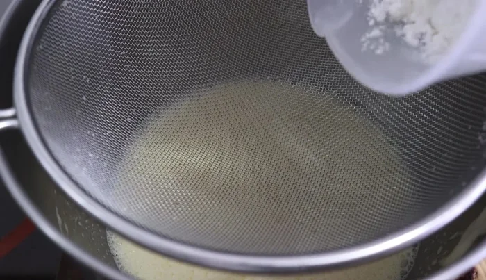 Sift 3 cups of wheat flour and 2 tablespoons of baking powder into the bowl with the melted butter and milk. Mix at medium speed.