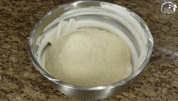 Gradually incorporate the Maseca flour, mixing until it resembles coarse sand.