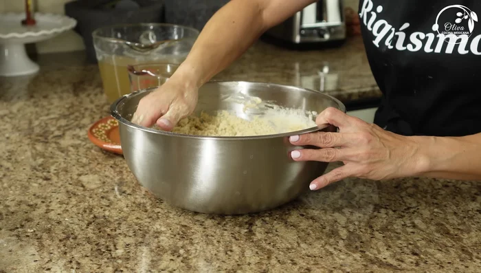 Add the consommé to the flour mixture, a cup at a time, until a soft, heavy dough forms. The total amount of broth needed might vary.