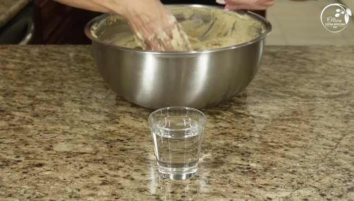 Check the dough’s readiness: A small portion should float in water, indicating proper lard integration.