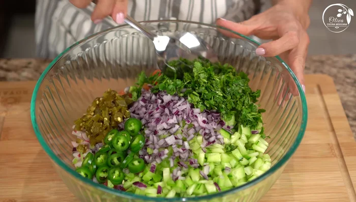 In a large bowl, combine lettuce, tomatoes, cucumbers, radishes, celery, onion, jalapeño peppers, cilantro, and tuna. Mix gently.