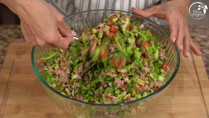 Add dressing in portions, mixing gently to coat evenly.