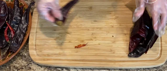 Clean and prepare the chiles: Remove stems and seeds from guajillo and chile de árbol chiles. Rinse thoroughly. (Optional: Lightly toast the chiles.)