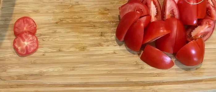 Prepare the tomato and onion: Cut tomatoes and onion into quarters. Sauté in a little oil until soft.