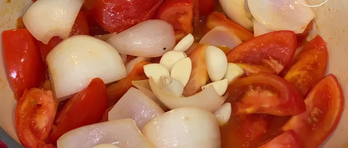 Make the marinade: Combine the sautéed tomatoes and onions with garlic, thyme, cumin, oregano, ginger, mustard seeds, peppercorns, paprika, cloves, coriander seeds, and cinnamon stick. Simmer gently for about 3 minutes, stirring constantly.