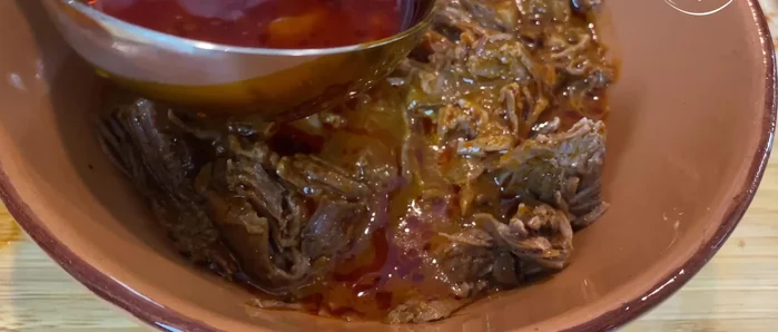 Serve: Serve the shredded beef birria hot in a rich consommé (broth), accompanied by warm tortillas and your favorite salsa.