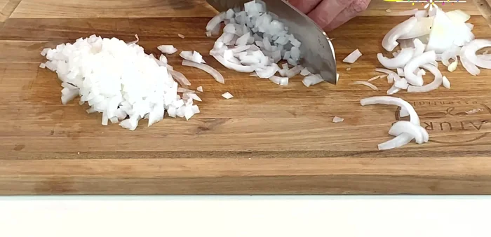 Finely chop the white onion into cubes. (128.71)
