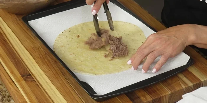 Fill each tortilla generously with the beef and potato mixture, fold into a chimichanga shape.