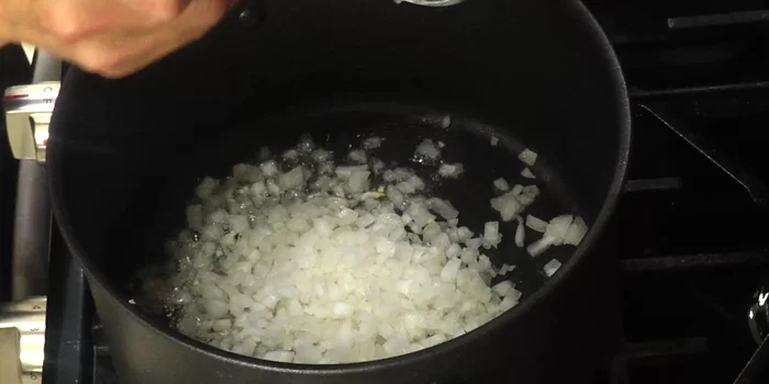 Add garlic and onion to the hot oil and sauté until softened and slightly browned.