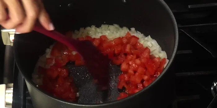 Add the chopped tomatoes and cook until they begin to soften and release their juices.