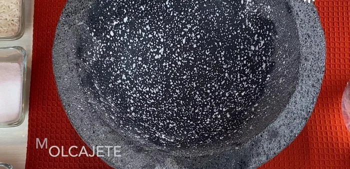 Clean the entire molcajete and tejolote with soap and water, scrubbing with a scouring pad and rinsing thoroughly.