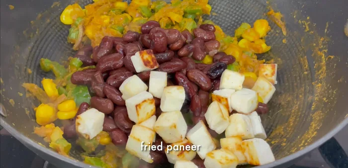 Add boiled kidney beans and the fried paneer to the pan. Mix well to infuse flavors.