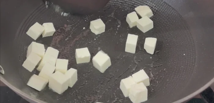 Spray oil (olive oil) in a pan. Add paneer (or tofu/soya chunks) cut into small cubes, add a little salt, and stir-fry until light golden. Keep aside.