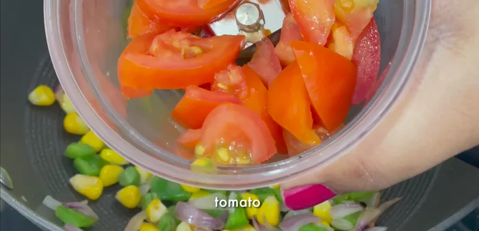 Blend tomatoes, green chilies, garlic, and ginger into a puree.