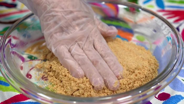 Press the cookie mixture into a buttered 9-inch pie dish, ensuring it's well compacted. Place more crust on the sides. Freeze the crust.