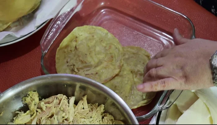 Layer four tortillas in a baking dish.