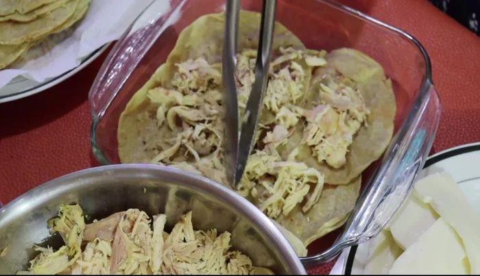 Add a layer of cooked and shredded chicken.