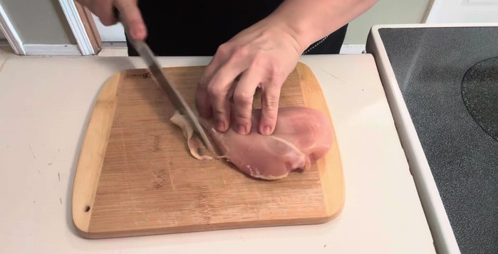 Heat a third of a cup of oil. Cut chicken breast into long, thin strips, then into squares. (Optional: Cook, shred, and fry chicken).