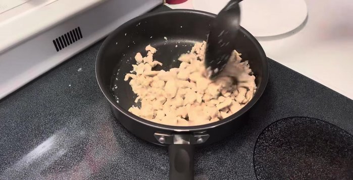 Once the chicken liquid evaporates, add onion and fry until golden brown. Add three large spoonfuls of the red sauce.