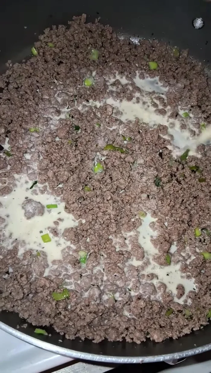 Add pet milk and chili to the ground beef. Bring to a boil, then simmer until slightly thickened.