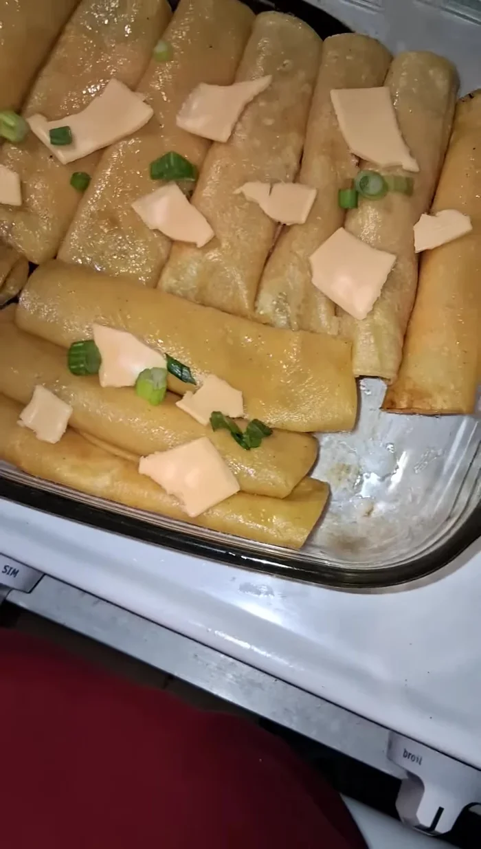 Assemble enchiladas: Fill each softened tortilla with a small amount of filling and a half slice of cheese. Roll up and place seam-down in a baking dish.