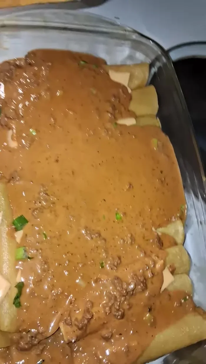 Pour the remaining cheese sauce evenly over the enchiladas.