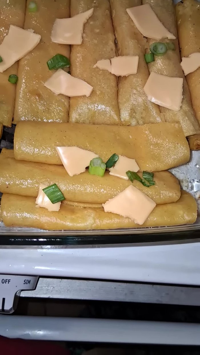 Soften corn tortillas (e.g., by steaming or microwaving).