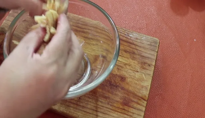 Shred the cooked chicken breast.