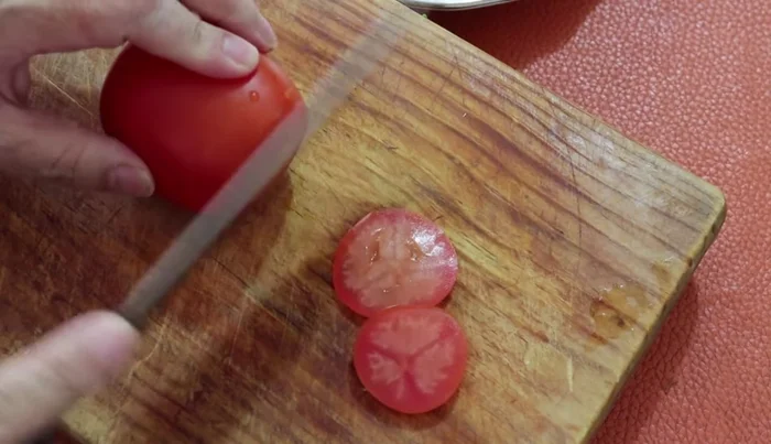 Slice one tomato.