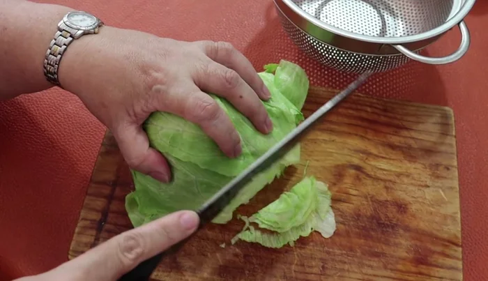 Wash, disinfect, and thinly slice romaine lettuce.