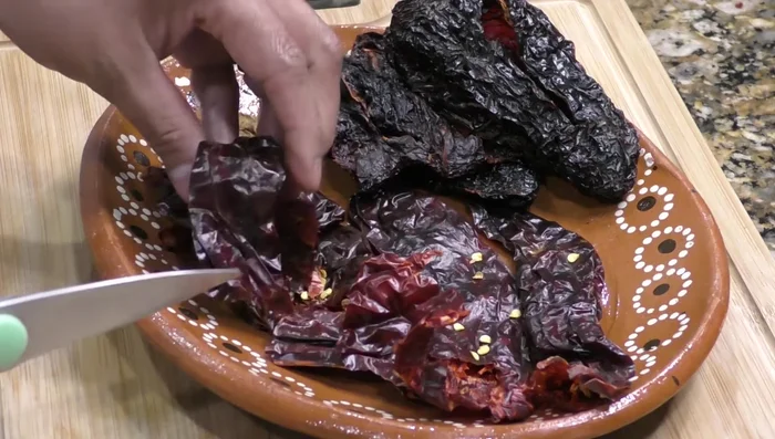 Cut the guajillo chiles into pieces.