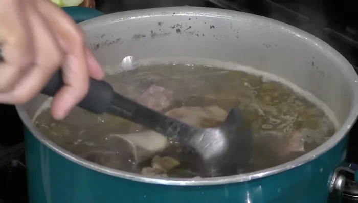 After 2 hours and 20 minutes of cooking, the beef should be tender. Add the corn to the pot.