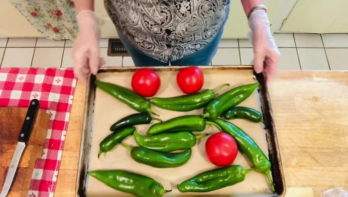Broil the chilies and tomatoes until they are dark and softened, flipping halfway through. This should take about 5-10 minutes, depending on your oven.