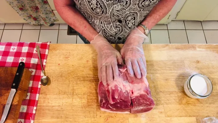 Once the pork is cooked, remove it from the oven and let it cool slightly. Cut the pork into chunks.