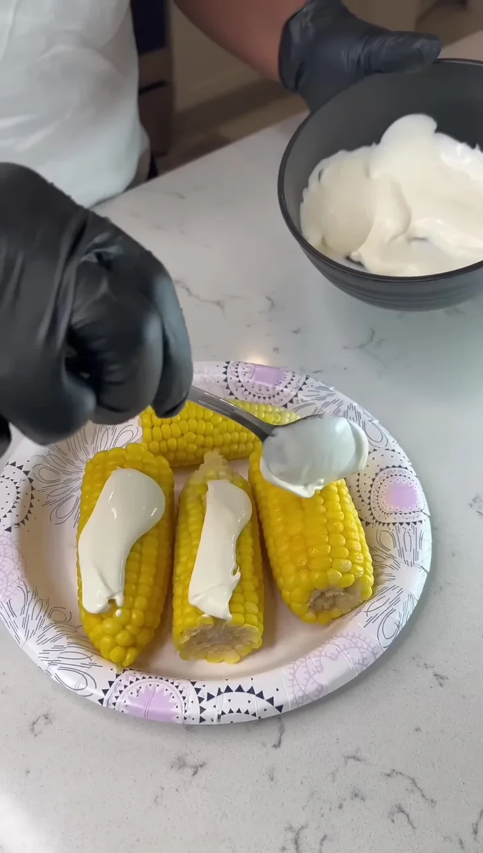 Generously spread the mayonnaise mixture over the corn.
