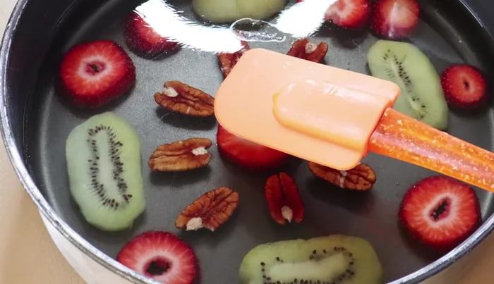 Pour the three-milk mixture over the fruit layer in the mold. Refrigerate for at least 3 hours or overnight until set.