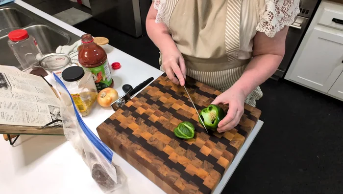 Prepare vegetables: Chop the green bell pepper and onion.